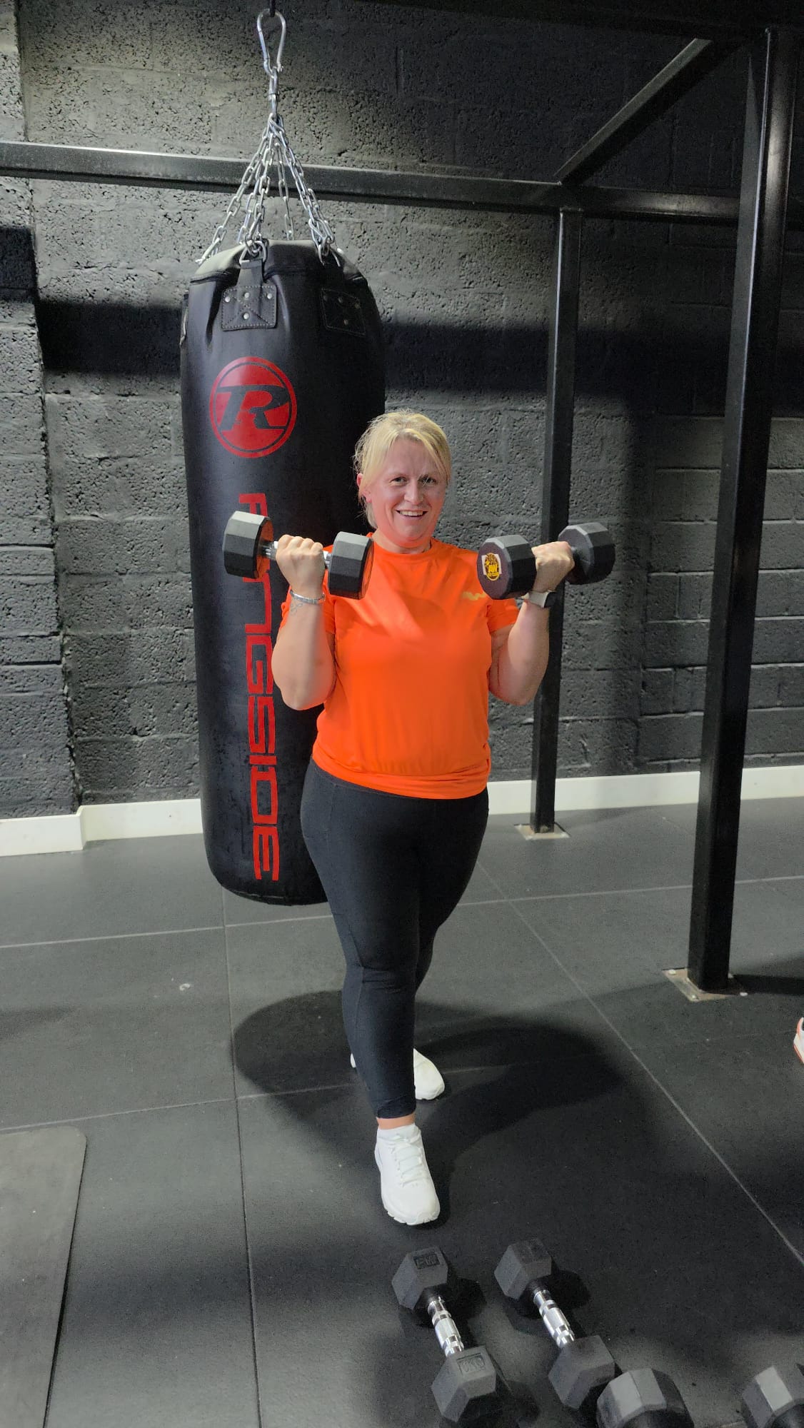 AW Fit Club member training with dumbbells